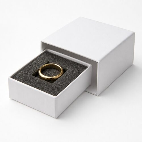 White drawer box tray pulled out with a gold ring sitting in the cut foam slot