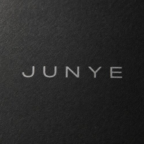 Foil stamped JUNYE logo on matte black specialty paper, custom drawer jewelry box detail