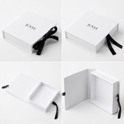 White flip box shown closed, with the bow loose, and open on its edge hinge revealing the white tray