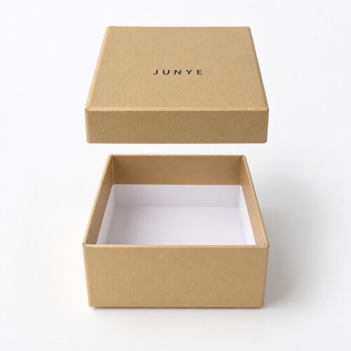 Gold jewelry box with the lid lifted vertically off the base, showing the white lined interior