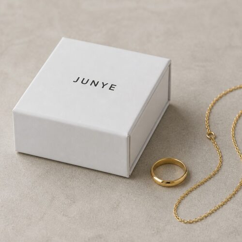 White drawer jewelry packaging box styled with a gold ring and chain