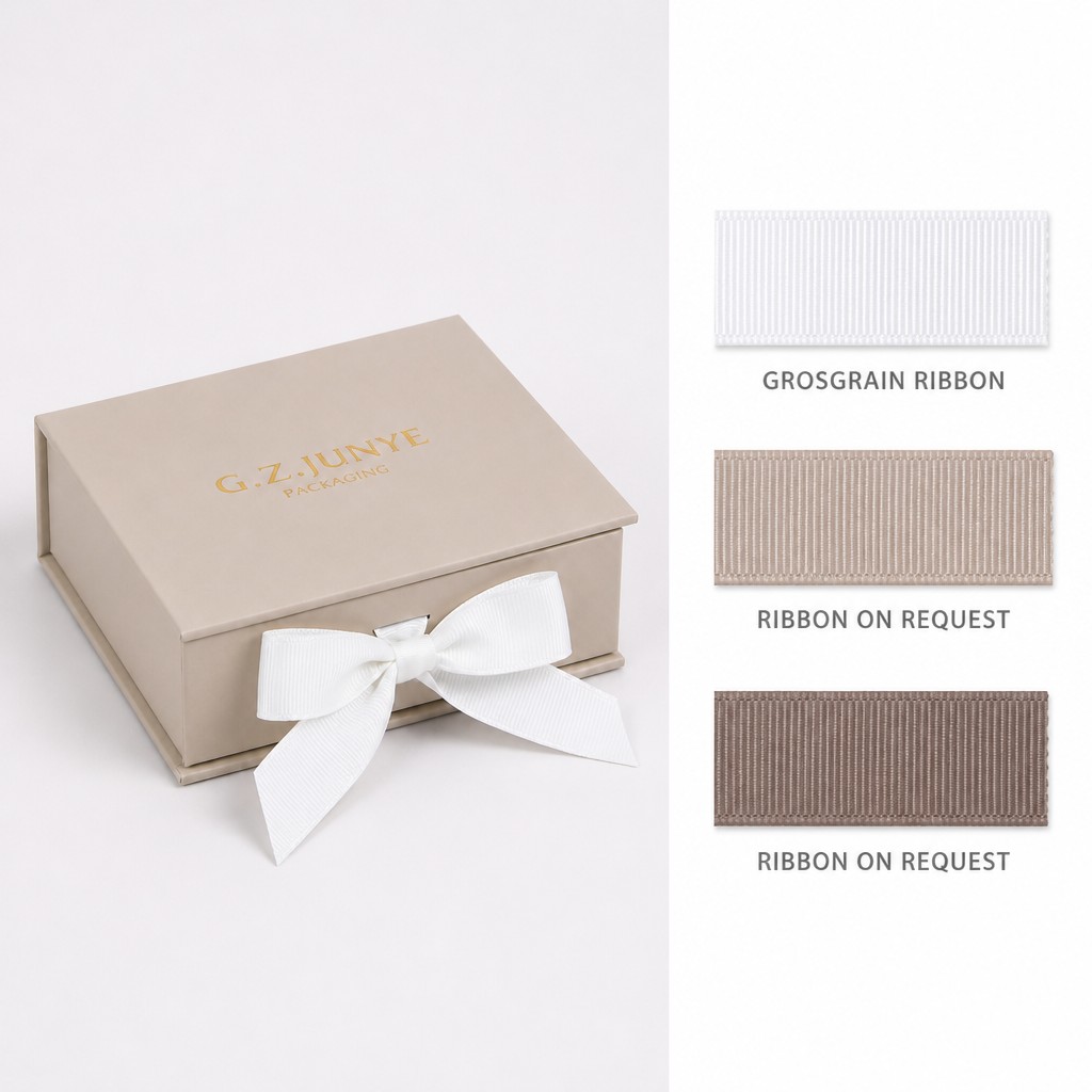 Beige flip jewelry box closed with a white ribbon bow tied at the front of the lid
