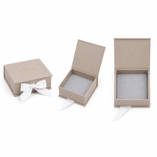 Four views of the beige flip jewelry box: closed with the bow, lid open on the hinge and the flocked tray from above
