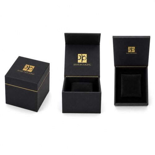 Four views of the black cube jewelry box: closed, lid open on the hinge, and the flocked tray from above