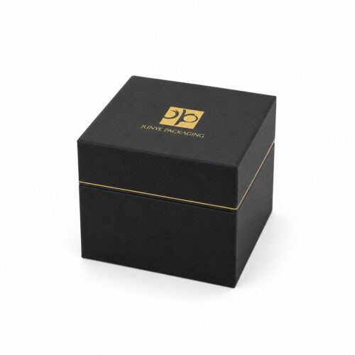 Black cube magnetic jewelry box closed, with the gold hairline running along the seam between lid and base