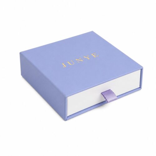 Blue bracelet drawer jewelry box closed, with the white tray face and satin ribbon pull