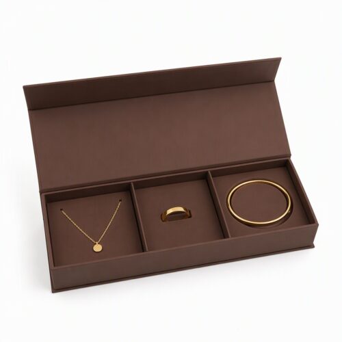 Three compartment gift set box open with a necklace, a ring and a bangle in separate compartments