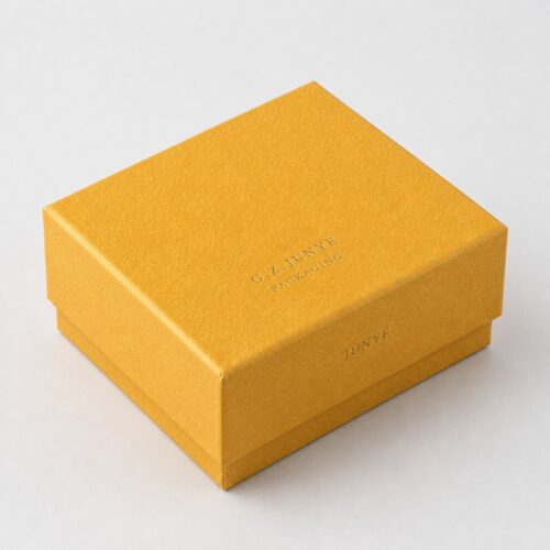Closed gold embossed rigid box showing the lid sitting over the base