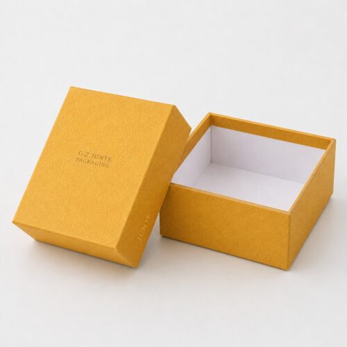 Lid lifted aside to show the white lined tray of the rigid gift box