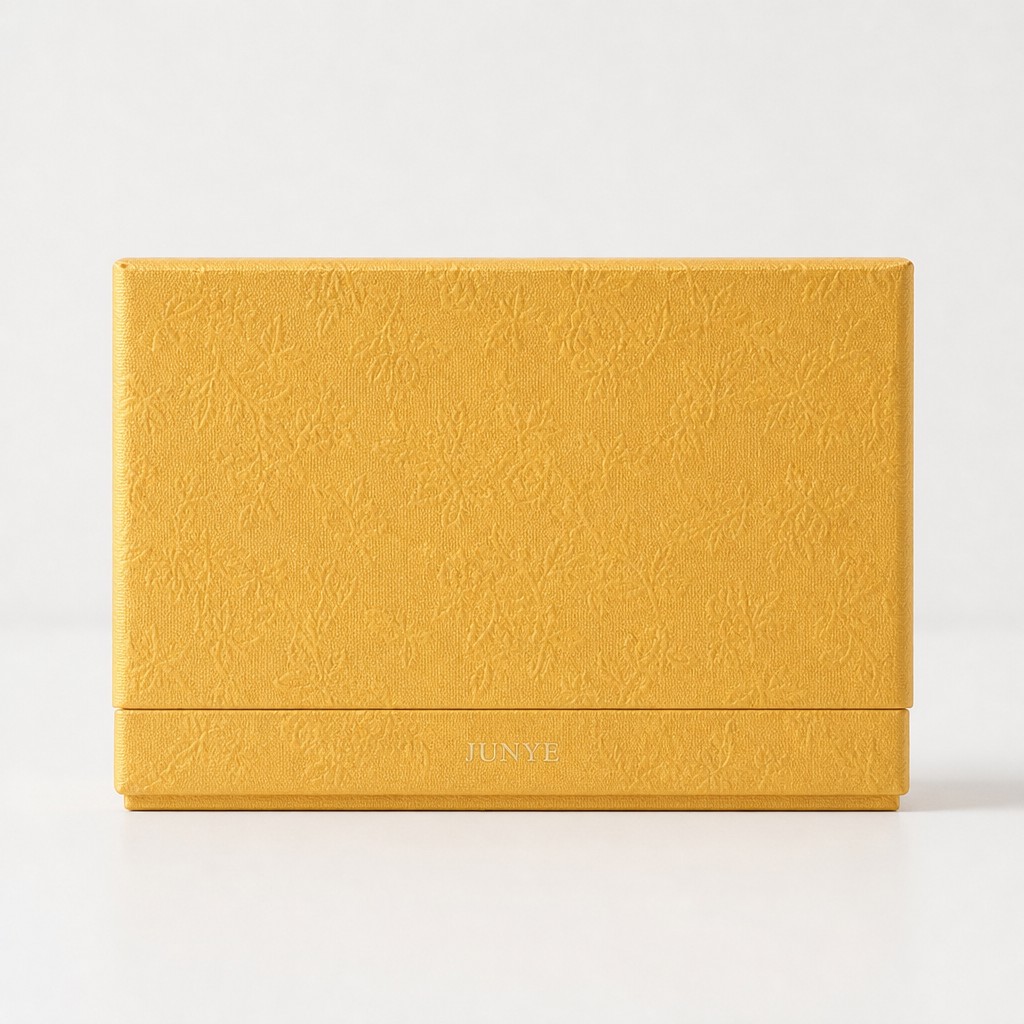 Orthographic front view of the closed gold embossed rigid box showing the lid seam at about four fifths of the height