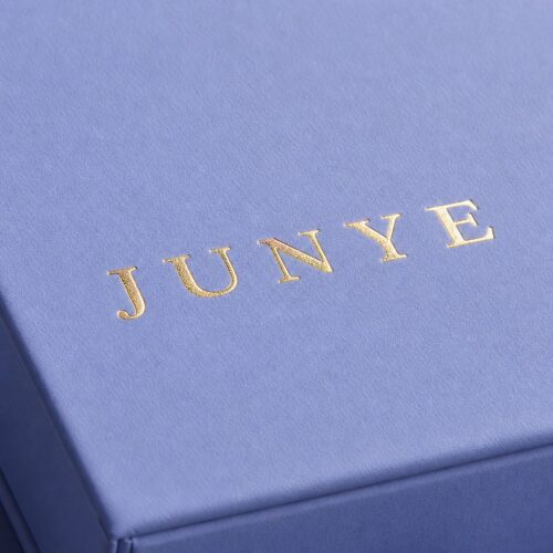 Gold foil logo on the blue paper wrap of a bracelet drawer jewelry box