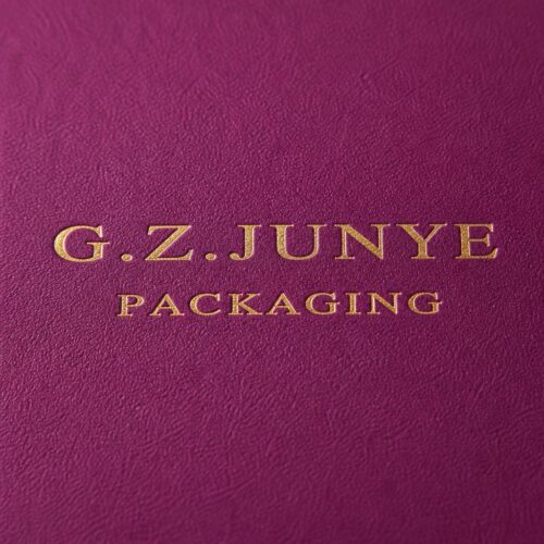 Gold G.Z.JUNYE PACKAGING stamp on the matte magenta specialty paper of a drawer jewelry box