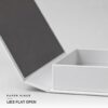 Cover swung flat on its paper hinge with the white tray open beside it