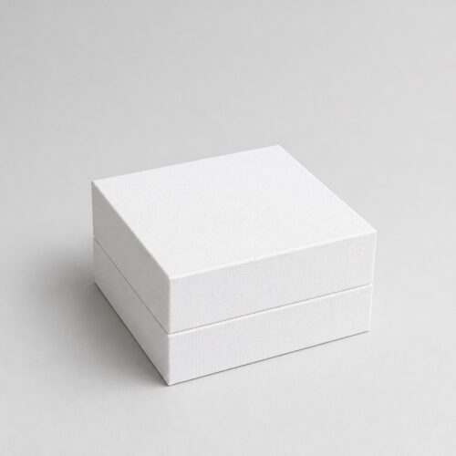 Closed white satin lined gift box at 45 degrees, the rim band step visible round the base