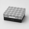 Closed telescopic lid box with a white scrollwork printed lid over a black folded base