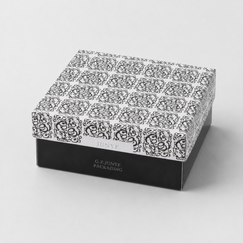 Closed telescopic lid box with the white ring and scroll printed lid over a black base